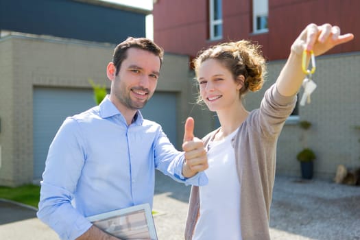 View of a Real estate agent handing over keys