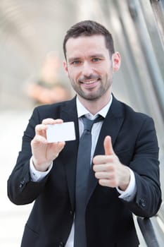 View of an Attractive businessman showing an empty textspace card