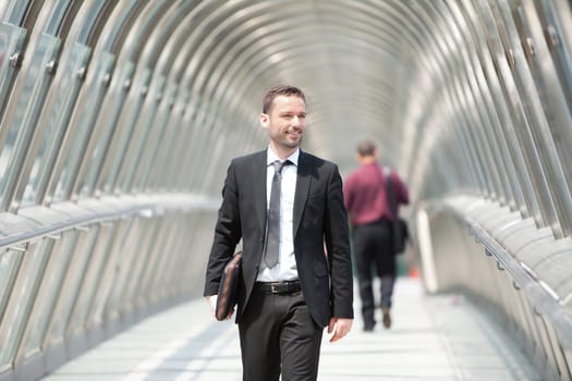 View of a Young attractive businessman on the way to his job