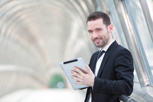 View of an attractive businessman using a tablet