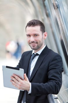 View of an attractive businessman using a tablet