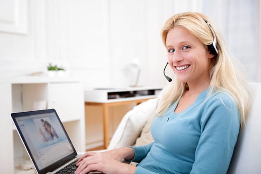 View of Young attractive woman blonde chatting on laptop
