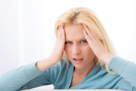 View of a Attractive blonde woman with headache