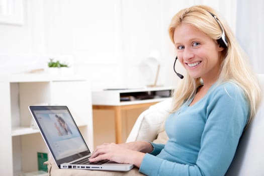 View of Young attractive woman blonde chatting on laptop