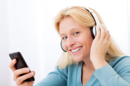 View of a young attractive woman listenning music