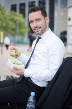 View of a Businessman eating salad for lunch break