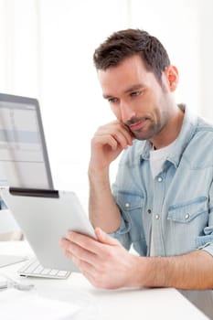 View of a Young relaxed man using tablet at home