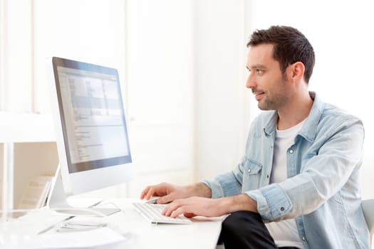 View of a young relaxed man using computer