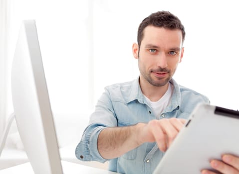 View of a Young relaxed man using tablet at home