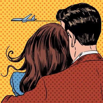 Loving couple looking at a plane taking off in the sky. A man and a woman hug and stand back