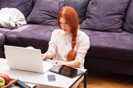 Young woman with laptop leisure time at home in living room