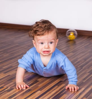 Portrait of a 7 months old baby boy at home.