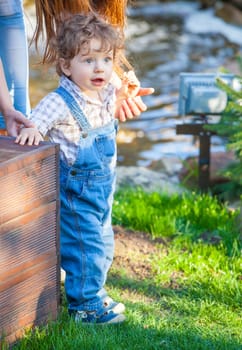 Portrait of 1 year old baby boy outdoor.