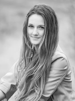 Outdoor portrait of beautiful teenage girl in spring in black and white.