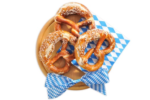 original Bavarian lye pretzels with salt with wooden plate on white background