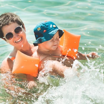 Baby and mother in a sea
