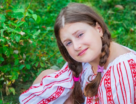 Portrait of a 10 year old girl wearing a Romanian traditional blouse.