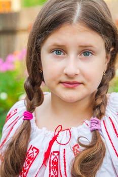 Portrait of a 10 year old girl wearing a Romanian traditional blouse.