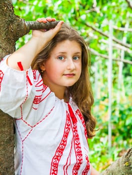 Portrait of a 10 year old girl wearing a Romanian traditional blouse.