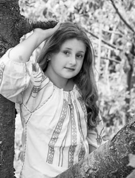 Portrait of a 10 year old girl wearing a Romanian traditional blouse.