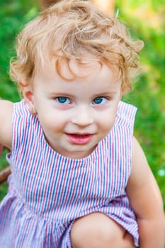 Portrait of 1 year old baby girl enjoying a day outdoor.