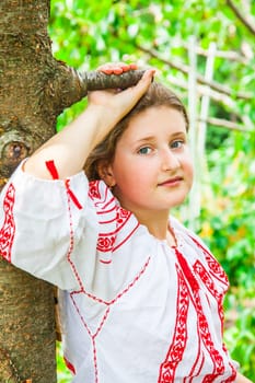 Portrait of a 10 year old girl wearing a Romanian traditional blouse.