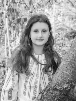 Portrait of a 10 year old girl wearing a Romanian traditional blouse.