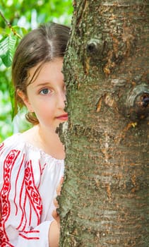 Portrait of a 10 year old girl wearing a Romanian traditional blouse.