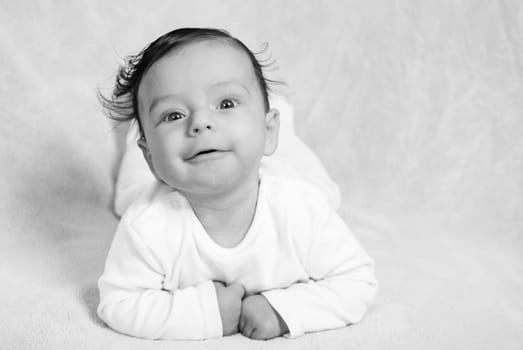 Portrait of an adorable baby boy in black ad white.