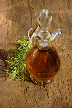 Glass carafe with olive oil and rosemary sprigs