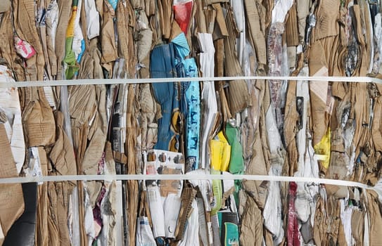 Recycling cardboard packaging concept with stacks of compressed baled corrugated paper garbage as a symbol to recycle for conservation