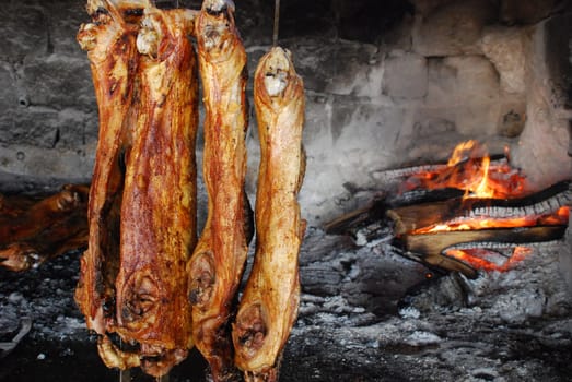 Sardinian specialty suckling pig at the wood-burning stove Maialino da Latte Sardo