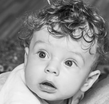 Portrait of a 7 months old baby boy at home with his toys.