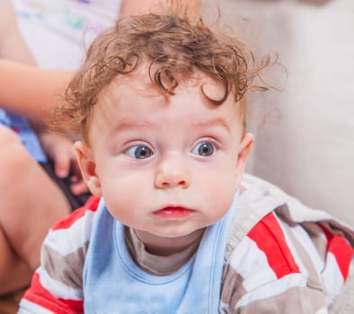 Portrait of 7 months old baby boy playing at home.