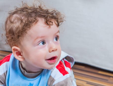 Portrait of 7 months old baby boy playing at home.