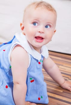 Portrait of 1 year old baby girl playing at home.