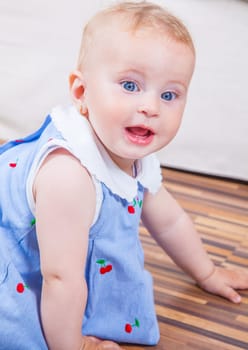 Portrait of 1 year old baby girl playing at home.
