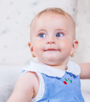 Portrait of 1 year old baby girl playing at home.