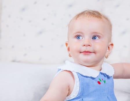 Portrait of 1 year old baby girl playing at home.