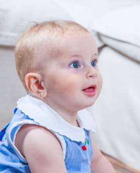 Portrait of 1 year old baby girl playing at home.