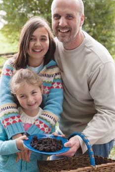 Father posing with his daughters
