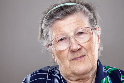 Closeup portrait of an elderly woman with glasses