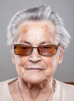 Closeup portrait of an elderly woman with glasses