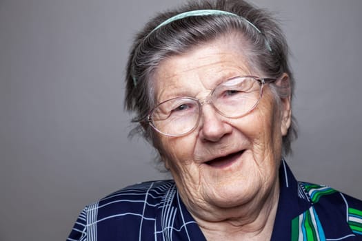 Closeup portrait of an elderly woman with glasses