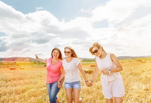 Three best friends having fun outdoors on a sunny day