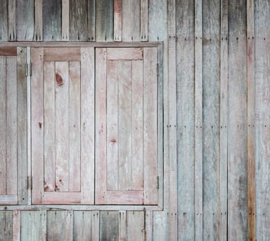 Asian wooden window with the hammered rusty nails on wooden wall background