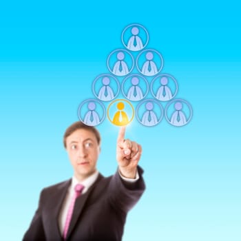 Focused manager is reaching up to single out by touch a male office worker at the bottom of a pyramidal hierarchy of male worker icons. Business metaphor for headhunt, success or discrimination.