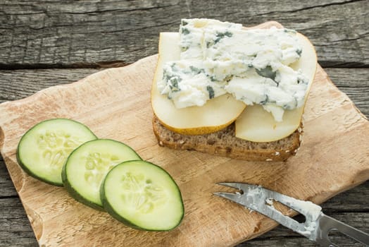 Bread rolls with cheese and pear with cheese knife