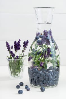 Flavoured water or infused water with blueberries and lavender in a carafe