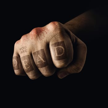Closed fist with death tattoo on the fingers. Concept of violent sports.